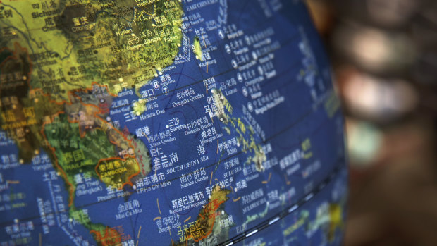 A globe shows the islands on the South China Sea with nine-dash line claims under Chinese territory on display at a bookstore in Beijing.