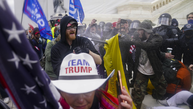 Trump supporters try to break through a police barrier at the Capitol on January 6.