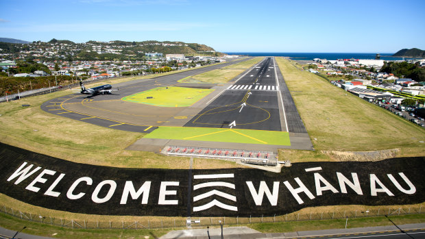 A giant sign painted near the main runway of the Wellington International Airport greets travellers returning home in Wellington.