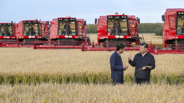 Chinese President Xi Jinping, right, visits a farm in Jiansanjiang, Heilongjiang province last month. His "Thought" has become compulsory study for Chinese people.