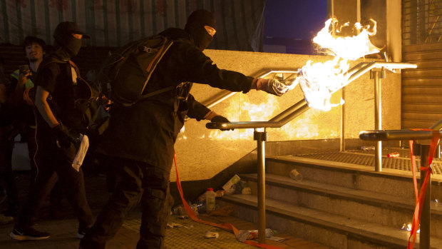 Pro-democracy protesters throw molotov cocktails to an entrance gate of Whampoa MTR station in Hong Kong last week.