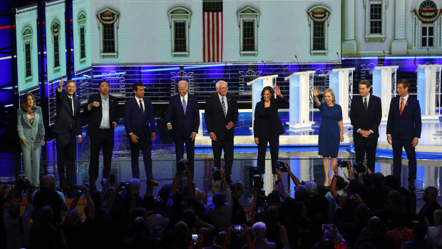 Democratic presidential candidates wave as they enter the stage for the second night of the Democratic primary debate in Miami. 