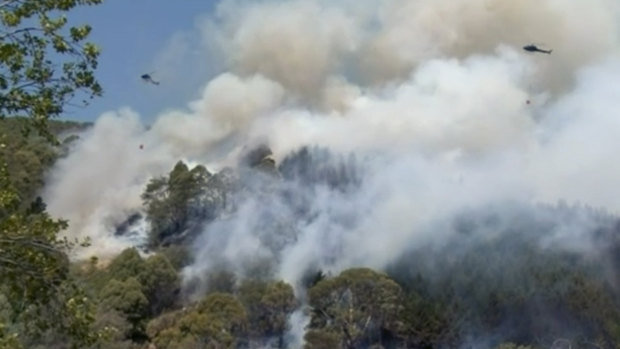 Helicopters drop water on a moving bushfire in Wakefield, New Zealand.