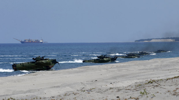 Amphibious assault vehicles carrying American and Philippine troops make a beach landing during a military exercise in the Philippines last year.
