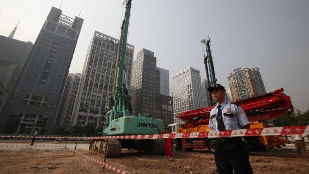 Security workers guard a construction site of the US Consulate compound in Guangzhou in southern China's Guangdong province. 