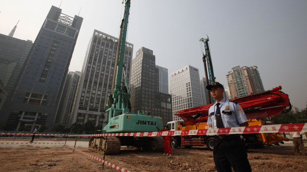 Security workers guard at construction site of the US Consulate compound in Guangzhou in southern China's Guangdong province. 