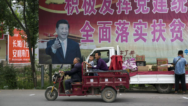 Chinese President Xi Jinping and part of a slogan that reads "Actively play the leading role of party building and comprehensively implement the plan for poverty alleviation" near Pingdingshan city in Henan province. 
