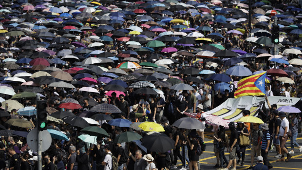 Protesters hold umbrellas as they march in Hong Kong earlier this month.