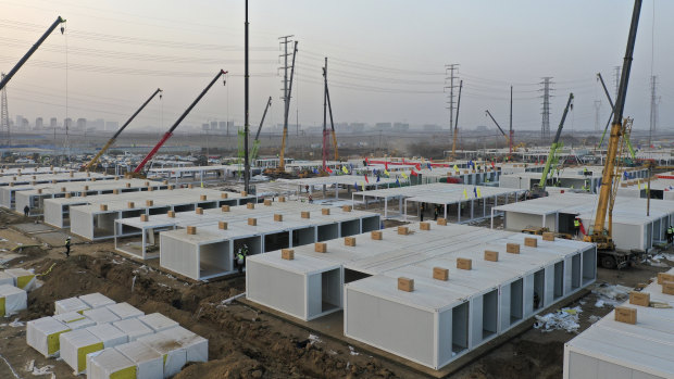 Workers build a large centralised quarantine facility capable of holding several thousand people in Shijiazhuang in northern China's Hebei Province. China on Saturday finished building a 1500-room hospital for COVID-19 patients in Nangong, south of Beijing in Hebei Province, to fight a surge in infections.
