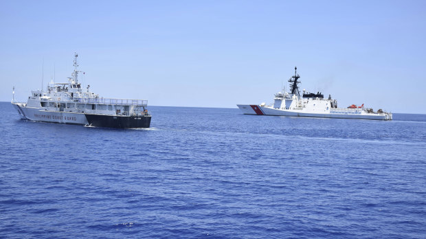 A US Coast Guard vessel, right, and a Philippine counterpart conduct joint exercises off the South China Sea west of the Philippines last year.