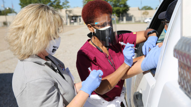 Healthcare workers administer a flu shot during a drive-thru clinic at the Louisiana State Fairgrounds in Shreveport, Louisiana, US.