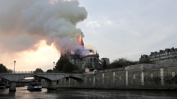 Notre-Dame burns by the river Seine.