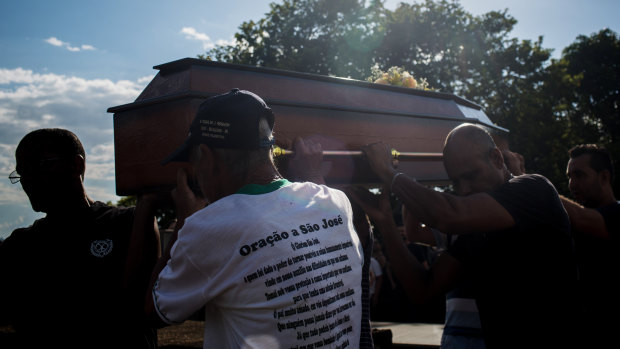 Relatives and friends attend the burial of a victim on Tuesday after a Vale dam burst in Brumadinho.