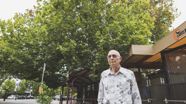 David Denham stands on Franklin Street, Manuka, in front of the protected London plane tree which appears to dying.