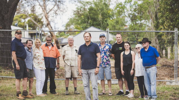Hall residents are angry about the ACT government's decision not to pursue a prosecution over the unauthorised demolition of a heritage-listed stone cottage. From left, Graeme Bryce, Bob Richardson, Helen White, Danny Clynk, Brian Banyard, Jonathan Palmer, John Sayers, Robert and Jordyn Collins, and Pam and Stan Sparrow.