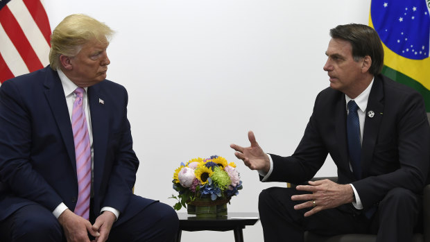 US President Donald Trump, left, meets with Brazilian President Jair Bolsonaro, right, during a bilateral meeting on the sidelines of the G20 summit in Osaka.