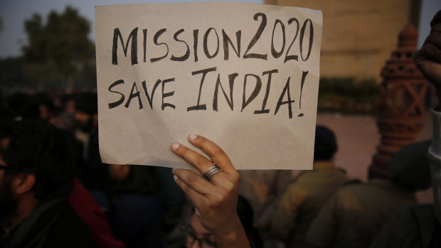 A student holds a placard during a protest against a new citizenship law in New Delhi.