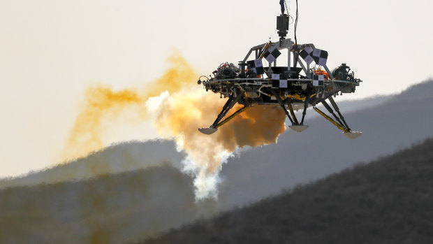 A lander is lifted during a test of hovering, obstacle avoidance and deceleration capabilities of a Mars lander at a facility in Huailai in China’s Hebei province. 