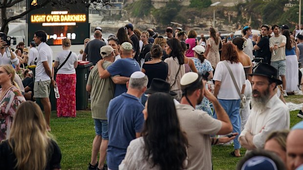 People gather for Sunday night’s memorial.