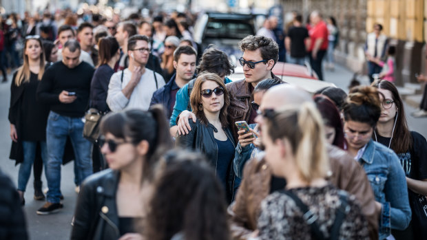 Voters wait in line outside of a polling station in Budapest, Hungary, on Sunday.