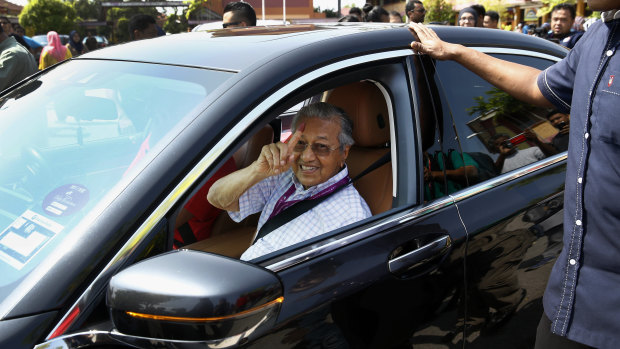 Former Malaysian strongman Mahathir Mohamad shows his finger after voting on Wednesday.