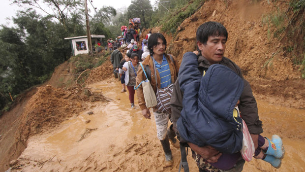 Residents and relatives of miners in Itogon, in the northern Philippines, evacuate following landslides triggered by Typhoon Mangkhut.