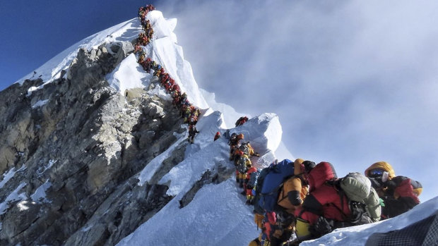 A photo of climbers lining up at the summit of Mount Everest has sparked a debate over deaths and traffic jams.