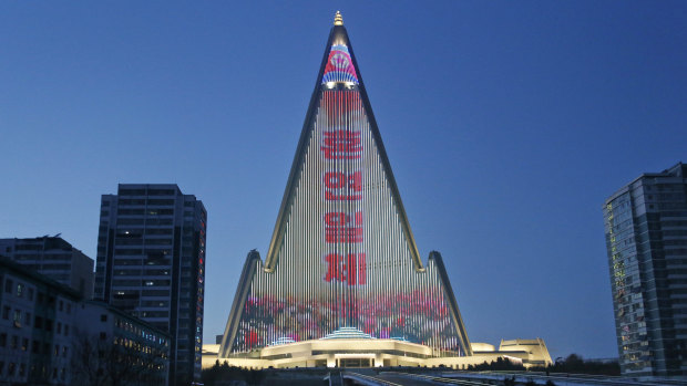 Propaganda messages are is displayed on the facade of the pyramid-shaped Ryugyong Hotel in Pyongyang.