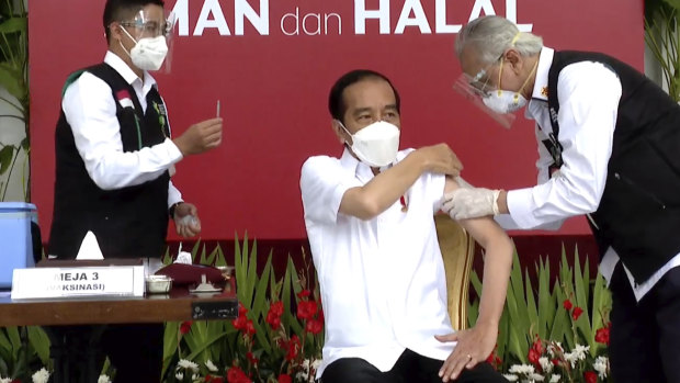 Indonesian President Joko Widodo, receives a shot against COVID-19 at the Merdeka Palace in Jakarta on Wednesday.
