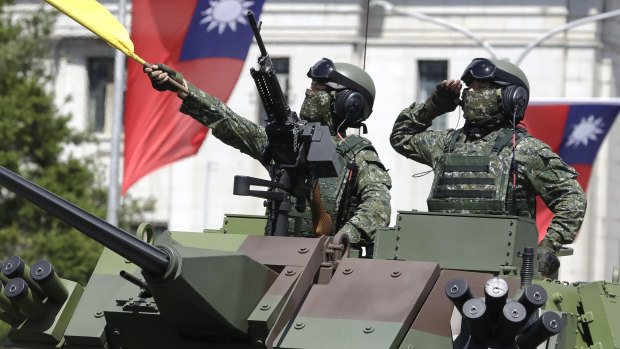 Taiwanese soldiers salute during National Day celebrations in front of the Presidential Office Building in Taipei in October. 