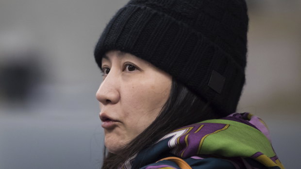 Huawei chief financial officer Meng Wanzhou talks with a member of her private security detail after they went into a wrong building while arriving at a parole office in Vancouver, British Columbia.