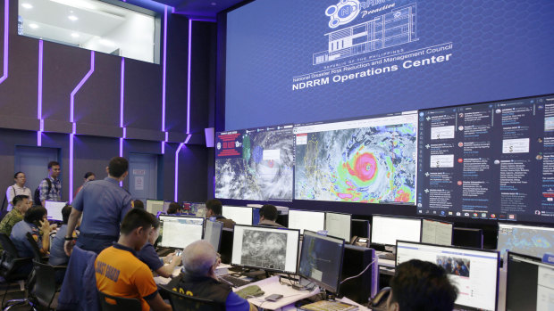 Images of typhoon Mangkhut, locally named "Typhoon Ompong" are seen at the National Disaster Risk Reduction centre in Manila.