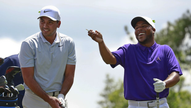 Lighter moment: Jason Day, sharing a laugh with Harold Varner, has slipped out of contention.