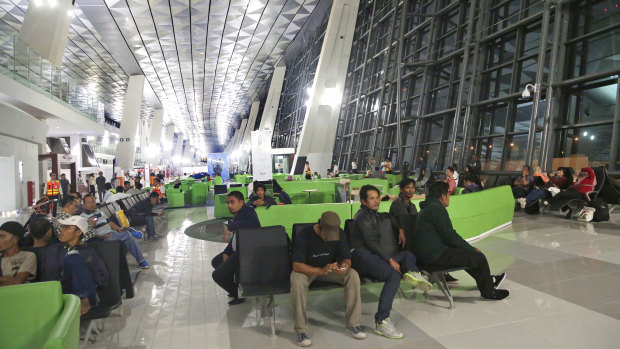 Passengers wait for their flights on the first day of operation of a new aiport terminal in Jakarta in 2016.