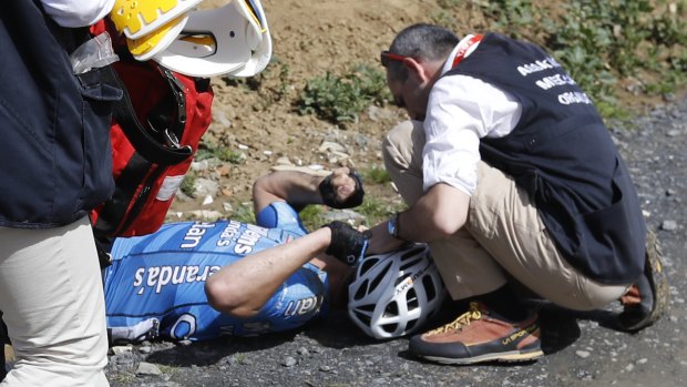 Veranda's Willems team rider Michael Goolaerts of Belgium is attended to by medics after allegedly suffering a cardiac arrest.