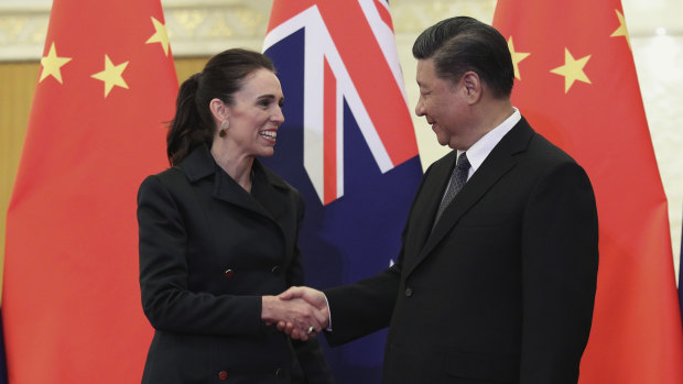 Chinese President Xi Jinping, right, and New Zealand Prime Minister Jacinda Ardern shake hands before their meeting at the Great Hall of the People in Beijing.