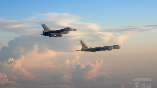 A Taiwanese Air Force fighter aircraft, left, flies near a Chinese People's Liberation Army Air Force (PLAAF) bomber that reportedly flew over the Luzon Strait south of Taiwan. 