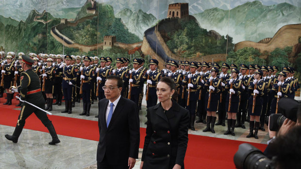 New Zealand Prime Minister Jacinda Ardern walks with Chinese Premier Li Keqiang after inspecting an honour guard during a welcome ceremony at the Great Hall of the People in Beijing on Monday, April 1.