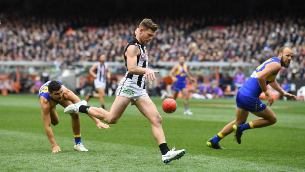 Adams kicks a goal for the Magpies.
