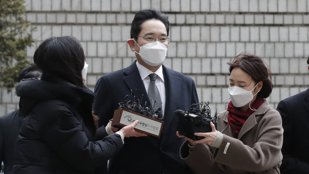 Samsung Electronics vice chairman Lee Jae-yong, centre, is questioned by reporters upon his arrival at the Seoul High Court on Monday.