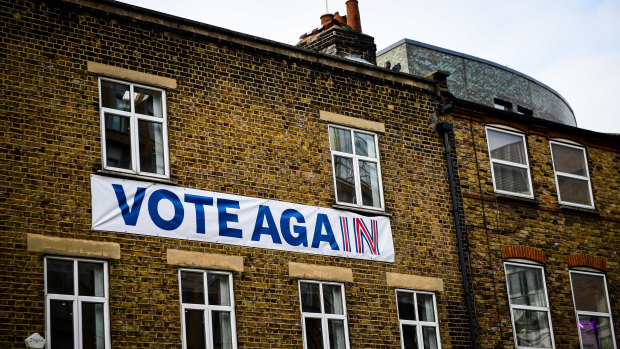 A banner reading "Vote Again" using branding from the Britain Stronger in Europe campaign hangs on an architect's office in London on Friday.