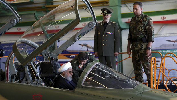 Iranian President Hassan Rouhani is briefed by an air force pilot as he sits in the cockpit of a fighter jet, before an inauguration ceremony of the aircraft in Iran last week.