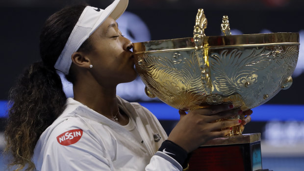 Golden moment: Naomi Osaka of Japan kisses her winner's trophy after her victory in the women's final at the China Open.