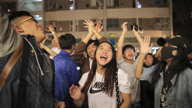 Pro-democracy supporters celebrate after pro-Beijing politician Junius Ho lost his election in Hong Kong. 