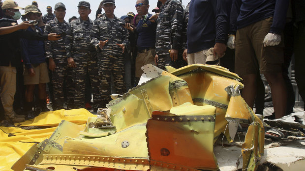 Navy personnel gather around debris recovered from the sea where the Lion Air jet is believed to have crashed in the waters of Tanjung Karawang, Indonesia, on Thursday.