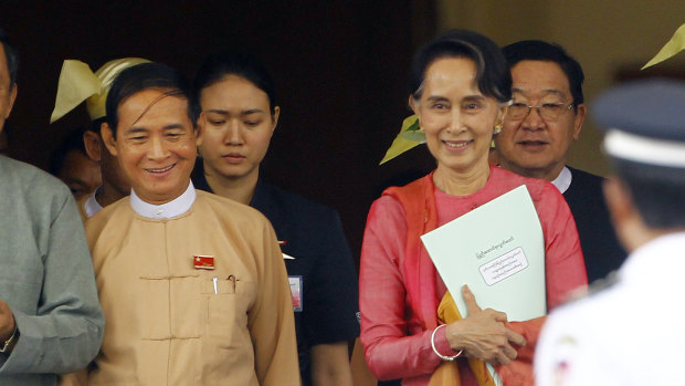 Win Myint, newly elected president of Myanmar, left, and the country's de facto leader Aung San Suu Kyi leave the Parliament on Wednesday.