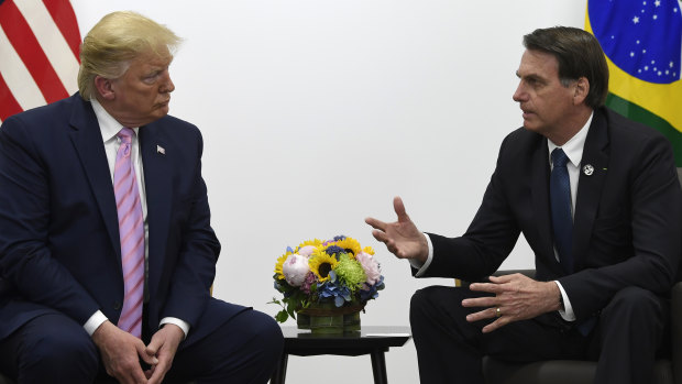 US President Donald Trump, left, meets with Brazilian President Jair Bolsonaro, right, during a bilateral meeting on the sidelines of the G20 summit in Osaka.