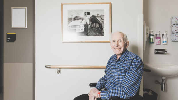 Dick Laurie with the photo from 1981 on the wall of his ward in the University of Canberra Hospital.