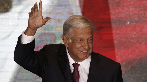 Presidential candidate Andres Manuel Lopez Obrador waves to supporters as he gives his first victory speech from his campaign headquarters in Mexico City on Sunday.