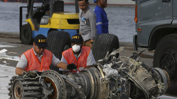 Officials inspect an engine recovered from the crashed Lion Air jet on Monday in Jakarta, Indonesia.